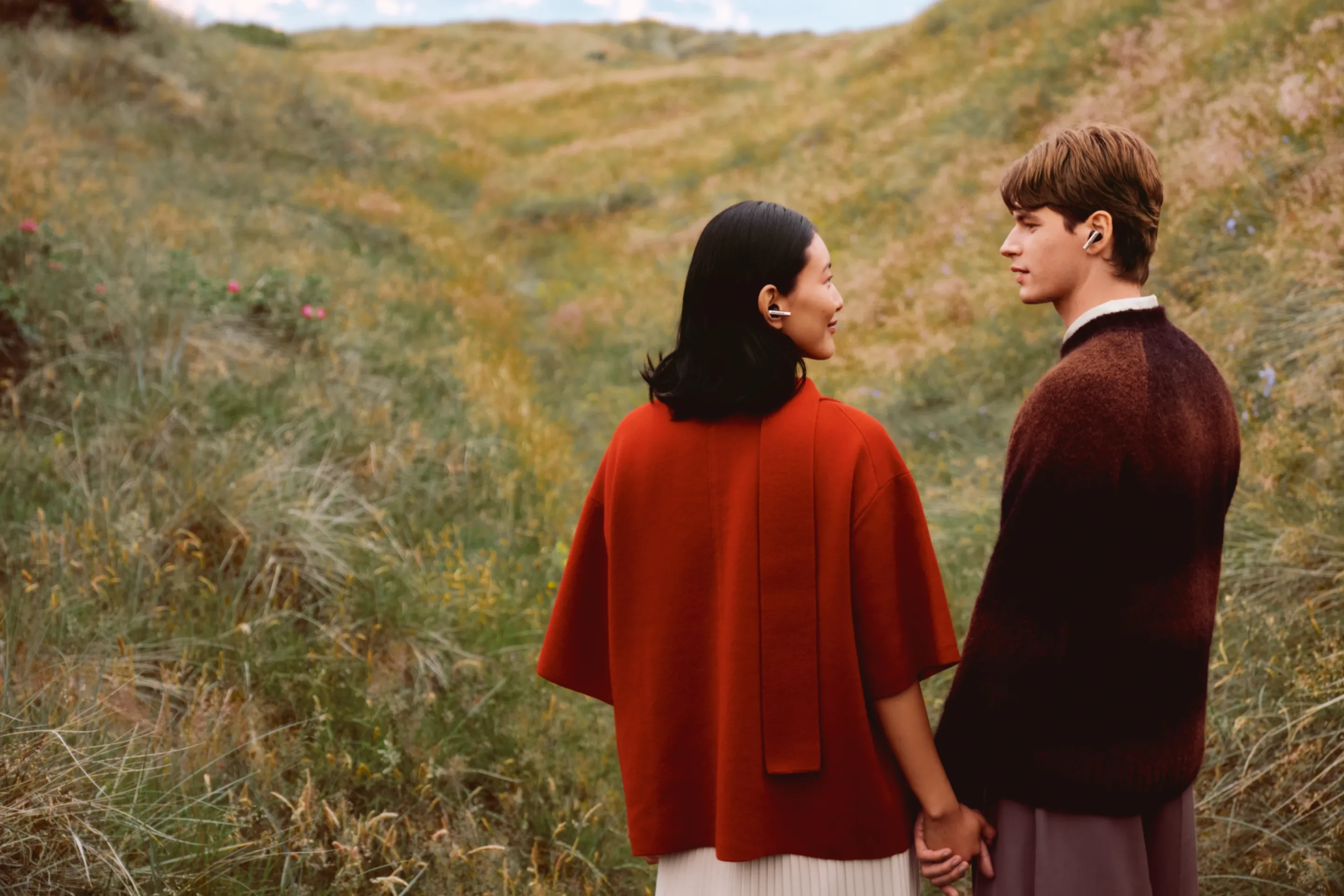 Two people standing next to each other while wearing Super Hoodie